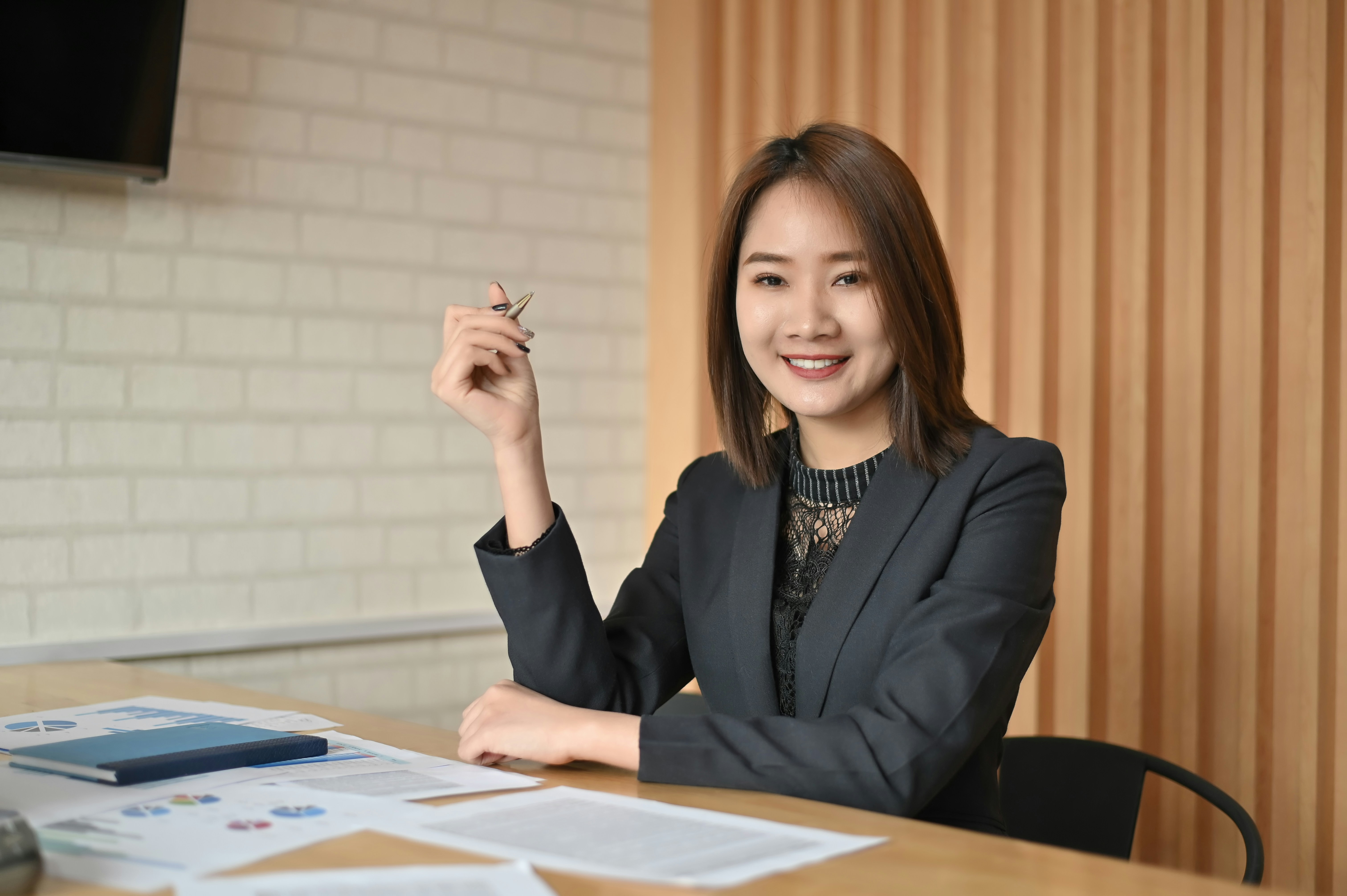 Professional woman at a desk reviewing documents, representing AI jobs and career growth in the AI industry.